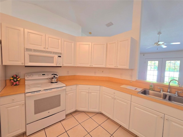 kitchen featuring white cabinetry, sink, white appliances, ceiling fan, and light tile patterned flooring