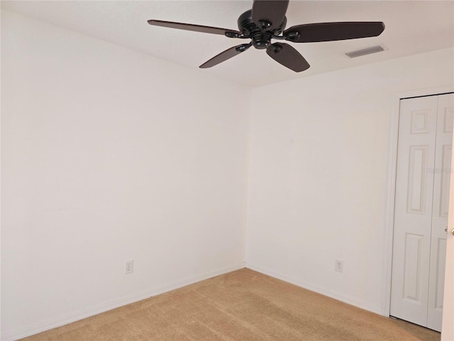 spare room with light carpet and ceiling fan