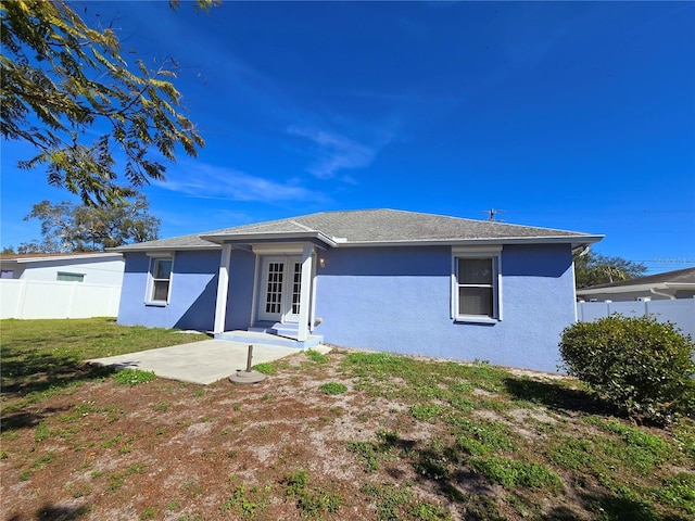 rear view of property with a patio and a yard