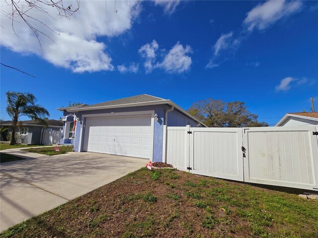 view of side of home featuring a garage