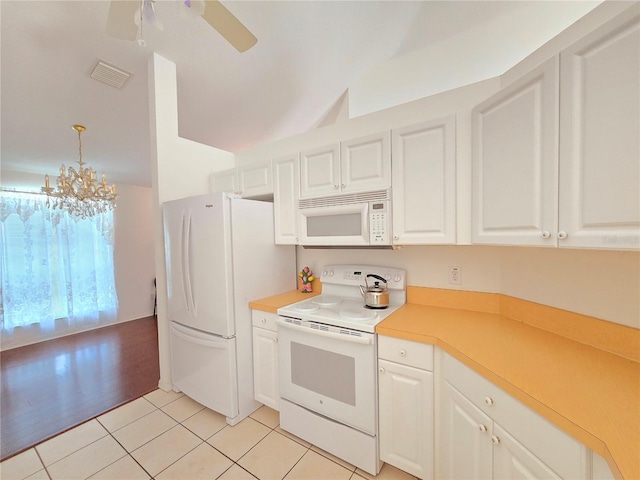 kitchen featuring white cabinetry, white appliances, light tile patterned flooring, and decorative light fixtures