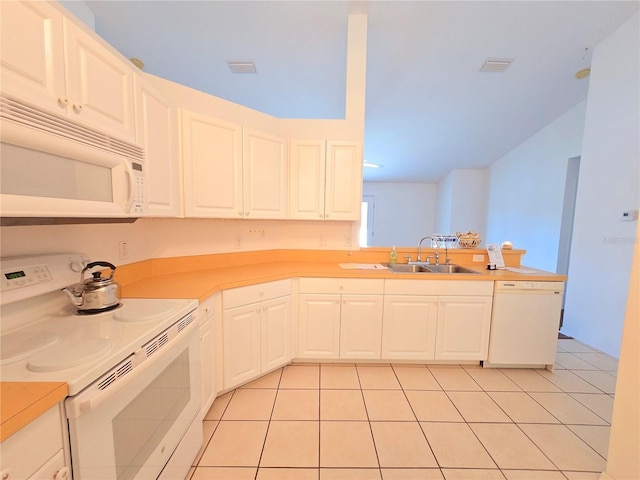 kitchen with white appliances, white cabinetry, sink, and light tile patterned floors