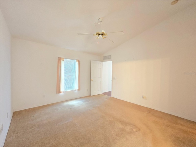 carpeted spare room with vaulted ceiling and ceiling fan