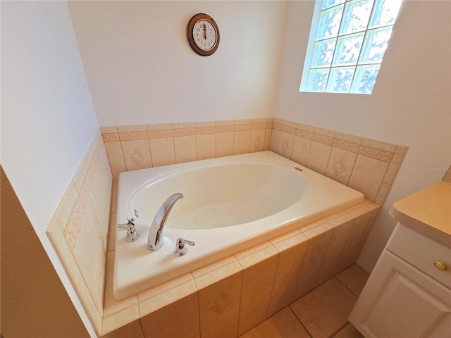 bathroom featuring vanity, tile patterned floors, and tiled bath