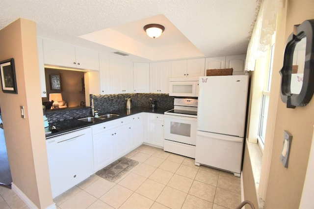 kitchen with white cabinets, a textured ceiling, white appliances, and backsplash