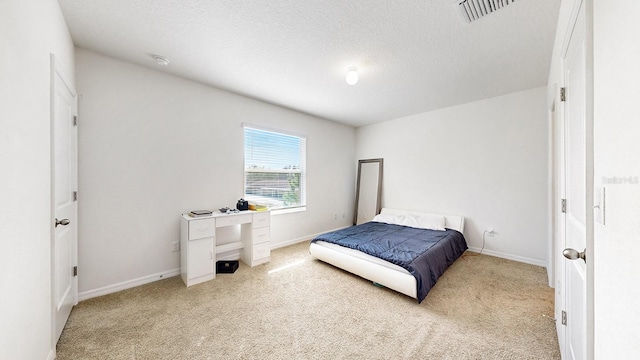 carpeted bedroom with a textured ceiling