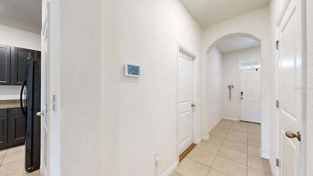 hall with light tile patterned floors