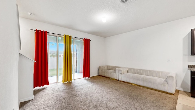 carpeted living room with a textured ceiling