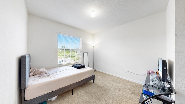 carpeted bedroom featuring a textured ceiling