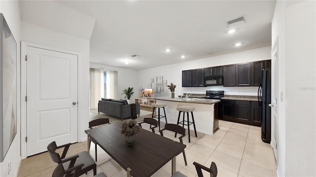 dining room with light tile patterned floors and sink