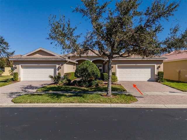 view of front of property featuring a garage and a front lawn