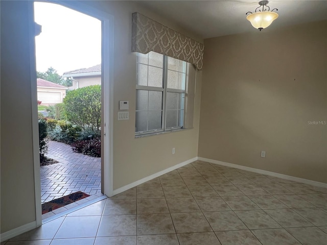 unfurnished dining area with light tile patterned flooring