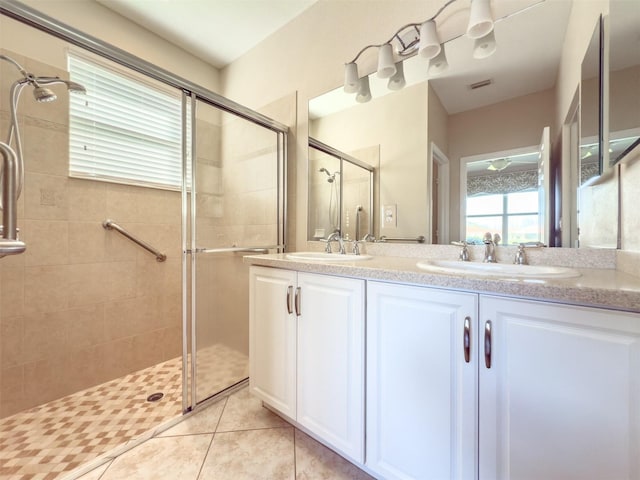 bathroom with vanity, tile patterned flooring, and walk in shower