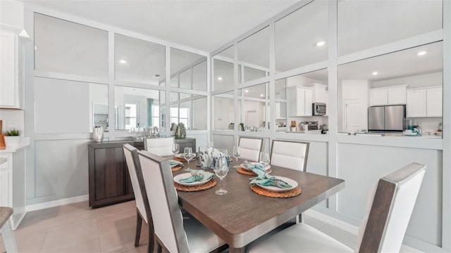 dining space featuring light tile patterned flooring