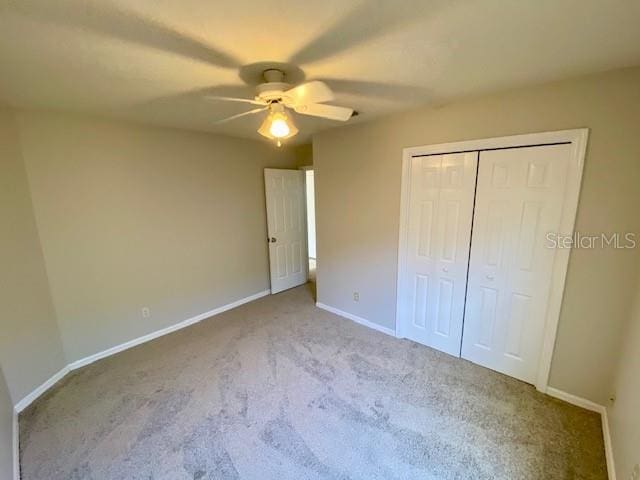 unfurnished bedroom with light carpet, a closet, and ceiling fan