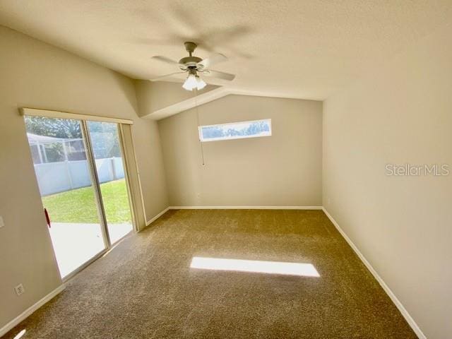 carpeted empty room featuring ceiling fan and lofted ceiling