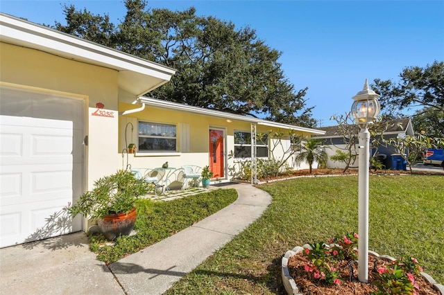 view of front facade with a garage and a front lawn