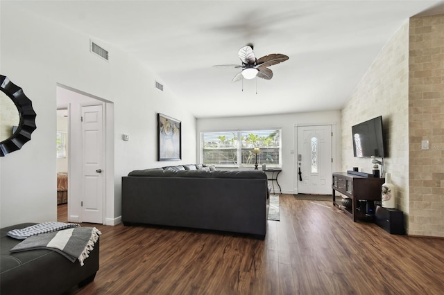 living room featuring ceiling fan and dark wood-type flooring