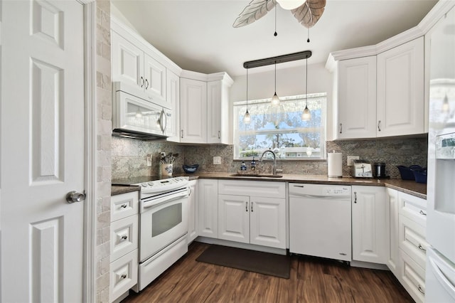 kitchen featuring white appliances, white cabinetry, dark wood-type flooring, and sink