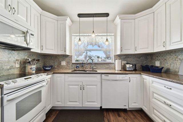 kitchen featuring white cabinetry, sink, decorative light fixtures, and white appliances