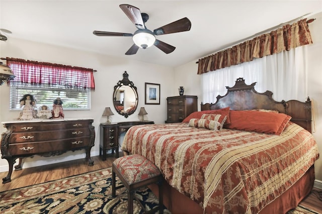 bedroom with hardwood / wood-style flooring, multiple windows, and ceiling fan