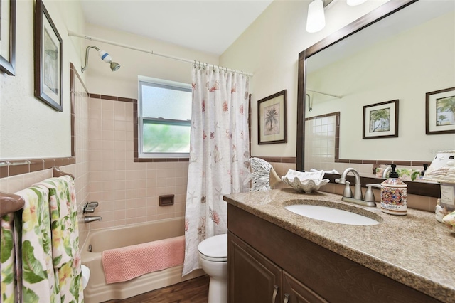 full bathroom with shower / bath combo, vanity, toilet, tile walls, and wood-type flooring