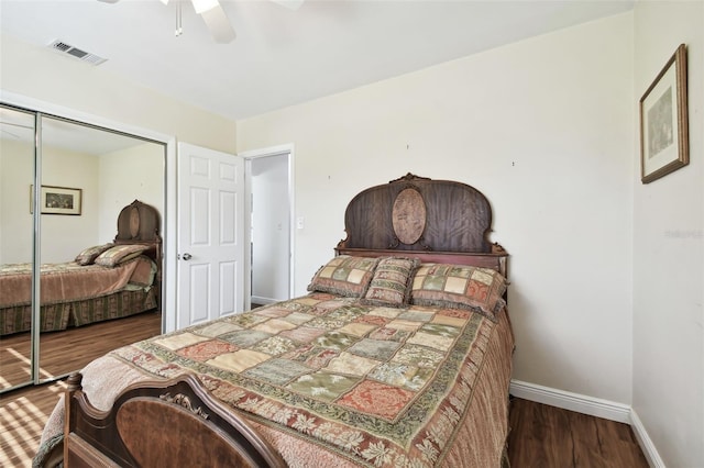 bedroom featuring ceiling fan, dark hardwood / wood-style flooring, and a closet