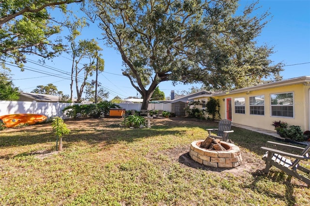 view of yard with an outdoor fire pit