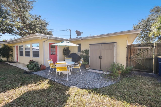 exterior space featuring a lawn and a storage shed