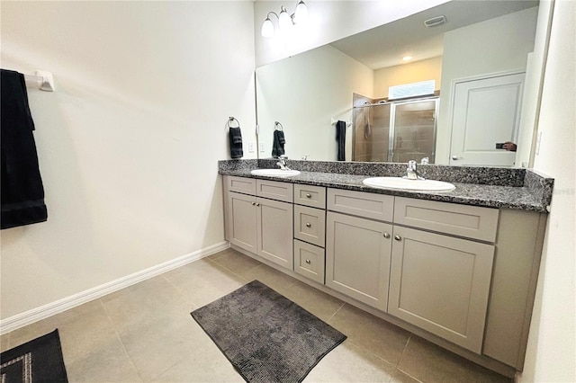 bathroom with tile patterned flooring, vanity, and a shower with shower door