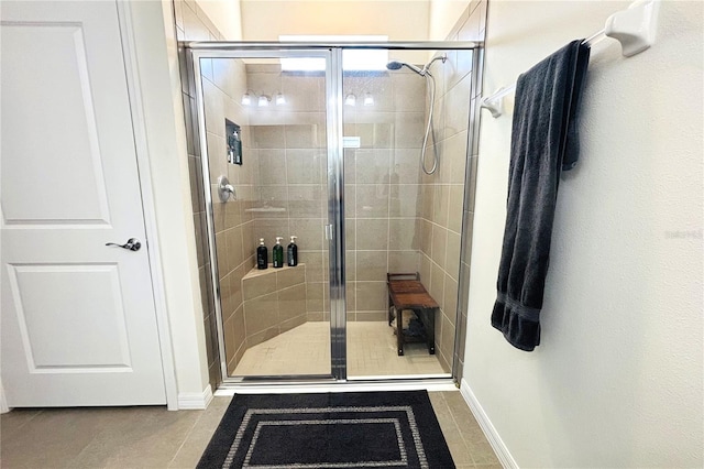 bathroom featuring tile patterned flooring and an enclosed shower