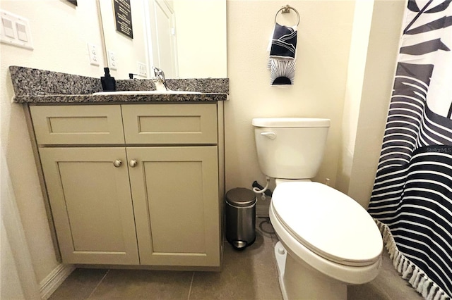 bathroom with tile patterned floors, vanity, and toilet