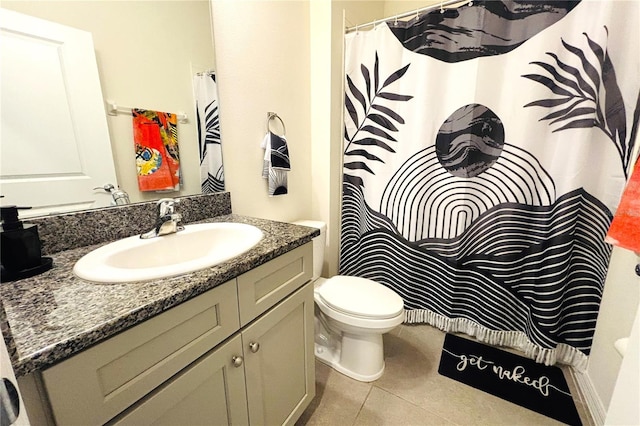 bathroom featuring tile patterned flooring, vanity, and toilet