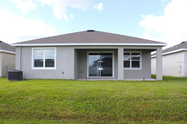 back of house featuring a yard and cooling unit