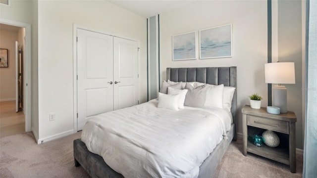 bedroom with light colored carpet and a closet