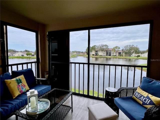 sunroom / solarium featuring plenty of natural light and a water view