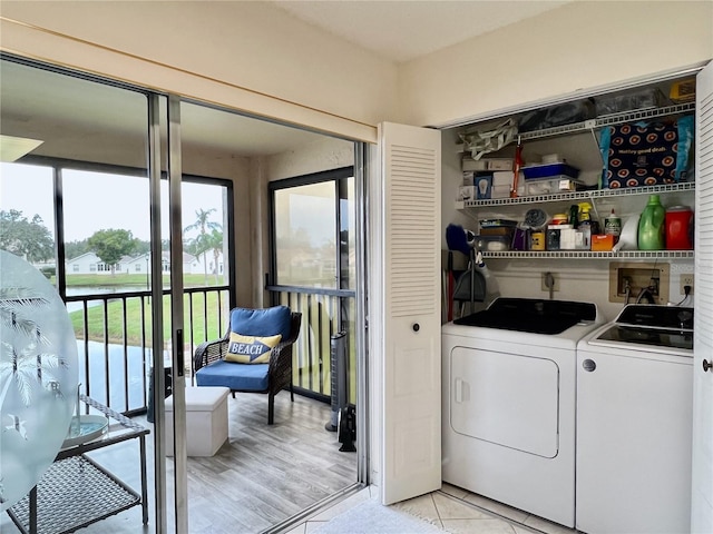 laundry area with light wood-type flooring and separate washer and dryer