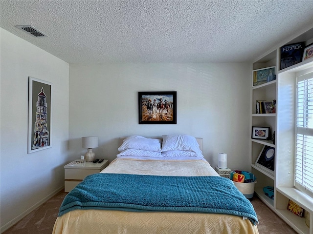 carpeted bedroom with a textured ceiling