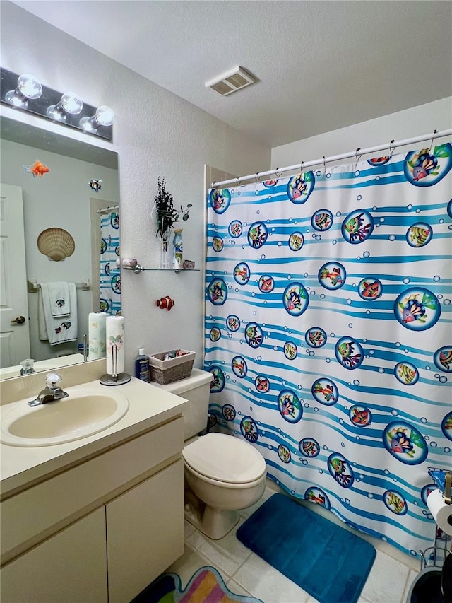 bathroom with a shower with curtain, tile patterned floors, a textured ceiling, toilet, and vanity