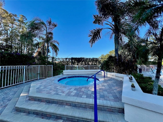 view of pool featuring an in ground hot tub