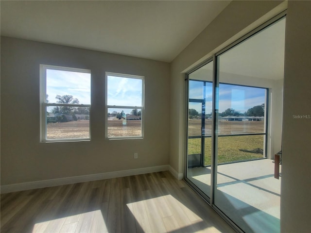 unfurnished room featuring hardwood / wood-style flooring