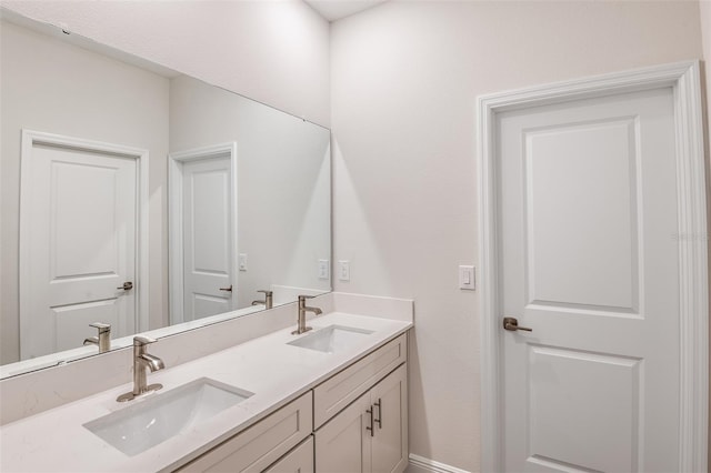 bathroom featuring a sink and double vanity