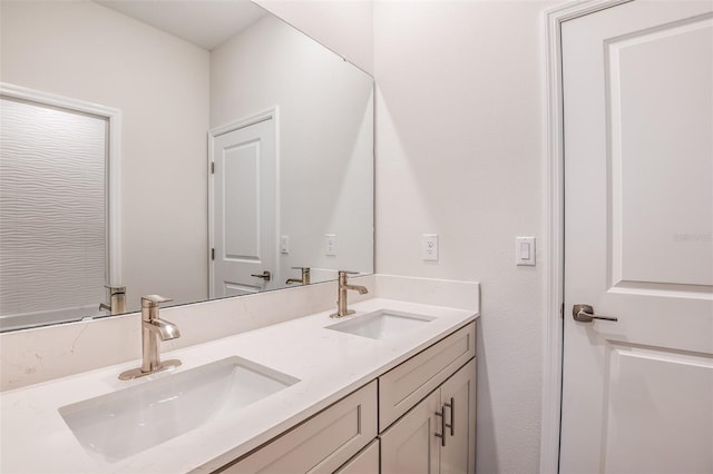 bathroom featuring a sink and double vanity