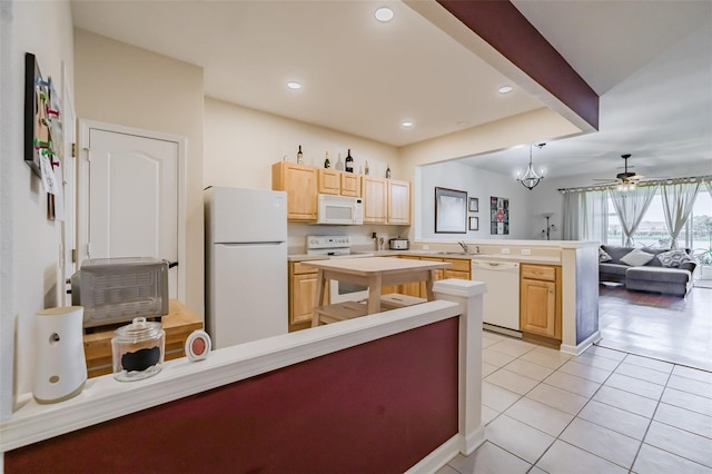 kitchen with kitchen peninsula, white appliances, ceiling fan with notable chandelier, light brown cabinets, and decorative light fixtures