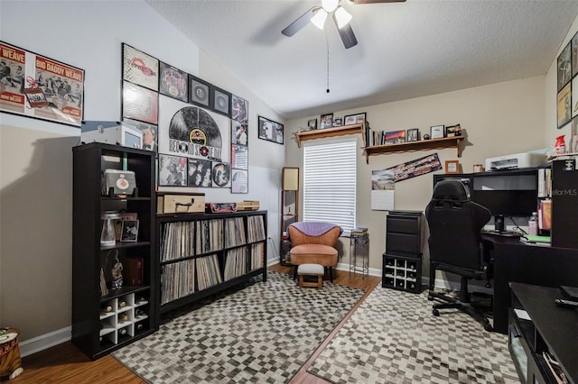 office area with hardwood / wood-style floors, a textured ceiling, vaulted ceiling, and ceiling fan