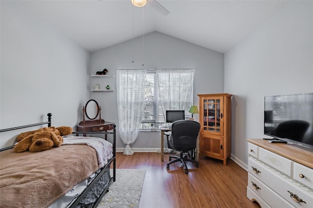 bedroom with ceiling fan, light hardwood / wood-style flooring, and lofted ceiling