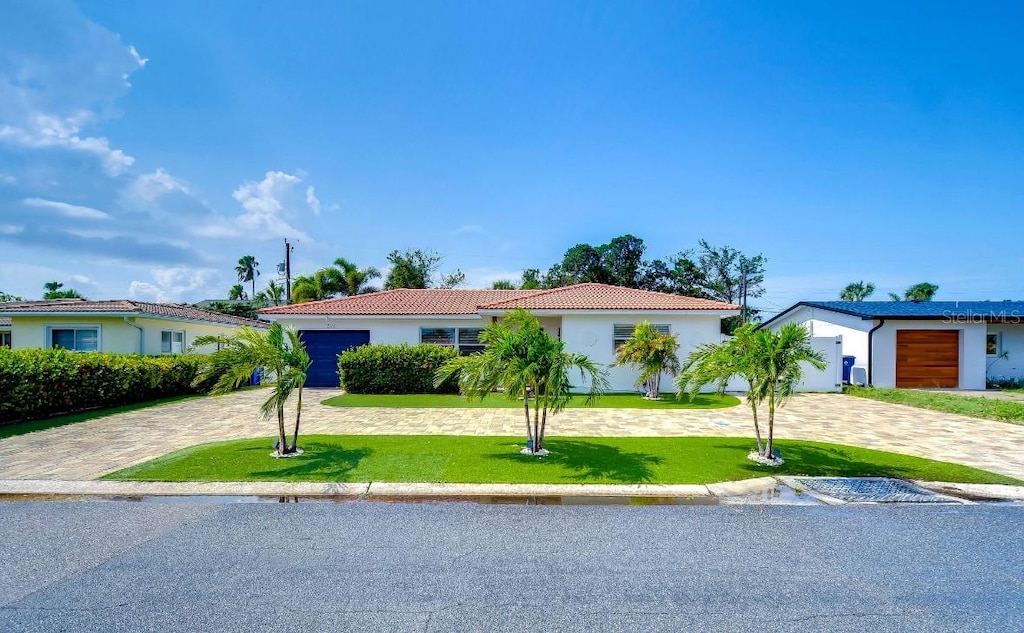 view of front of house with a garage and a front lawn