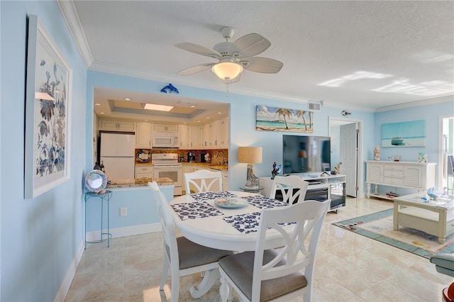 dining room with ceiling fan, light tile patterned floors, a textured ceiling, and ornamental molding