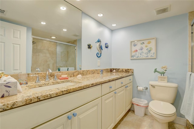 bathroom featuring tile patterned floors, vanity, toilet, and walk in shower