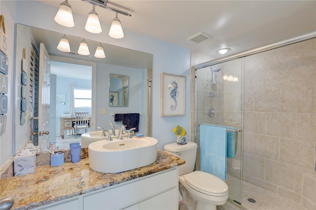 bathroom featuring vanity, toilet, and walk in shower